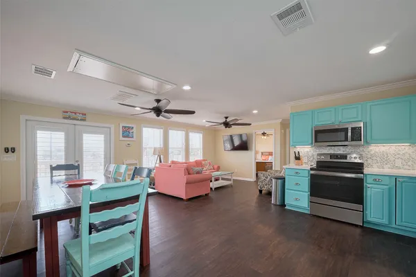 a kitchen with kitchen island granite countertop stainless steel appliances and refrigerator