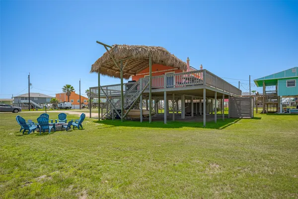 a view of a house with a yard and sitting area