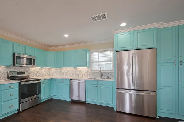 a kitchen with a sink stove and microwave