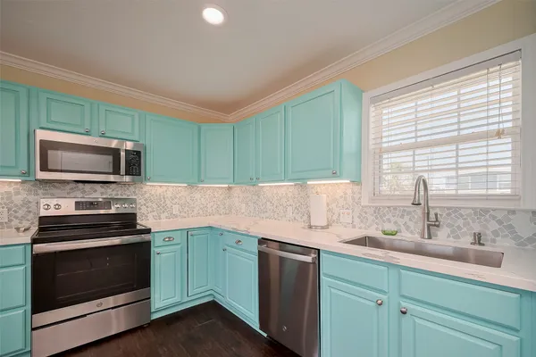 a kitchen with granite countertop cabinets stainless steel appliances and a sink