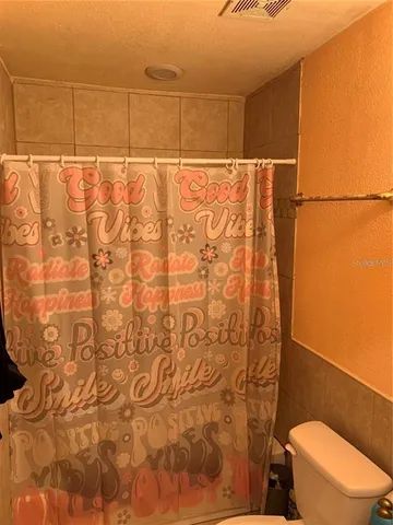 a bathroom with a toilet and shower