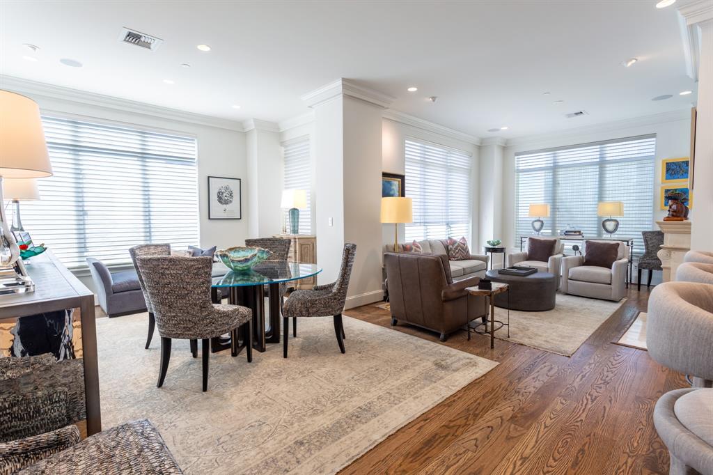 a living room with furniture a wooden floor and a window