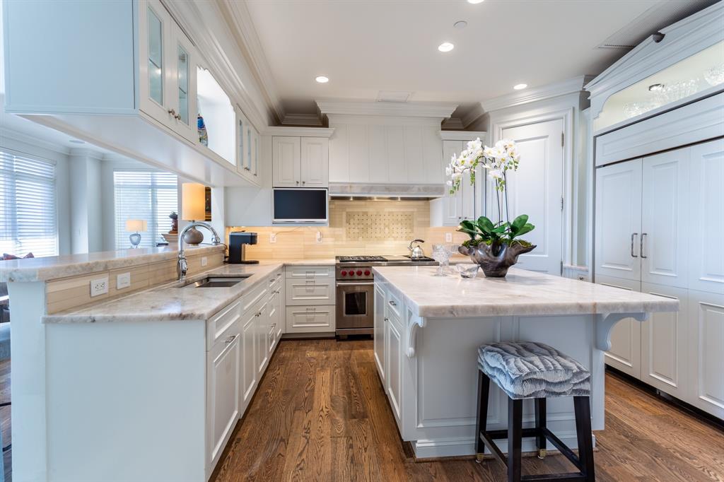2525 North Pearl Street, Unit 1005 Dallas, TX 75201 - Photo 12 of 40 a kitchen with kitchen island granite countertop lots of counter top space and stainless steel appliances