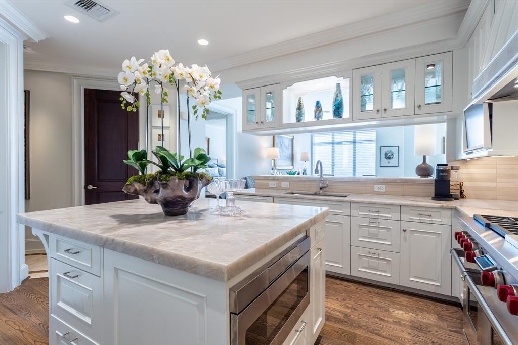 2525 North Pearl Street, Unit 1005 Dallas, TX 75201 - Photo 14 of 40 a kitchen with a sink a chandelier and wooden floor