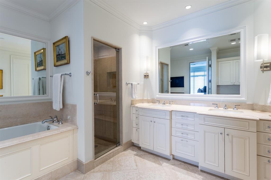 2525 North Pearl Street, Unit 1005 Dallas, TX 75201 - Photo 27 of 40 a bathroom with a sink double vanity granite tub shower and a mirror