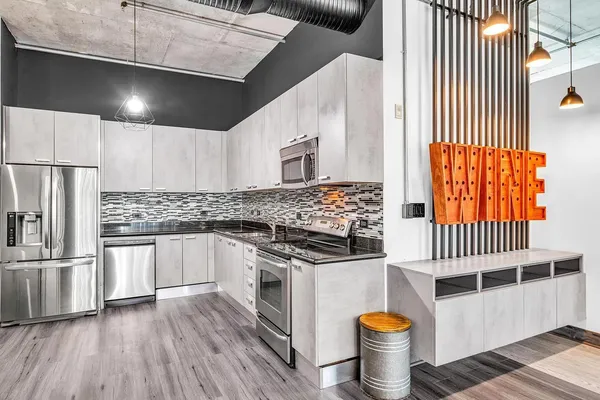 a kitchen with stainless steel appliances a stove a sink and a refrigerator