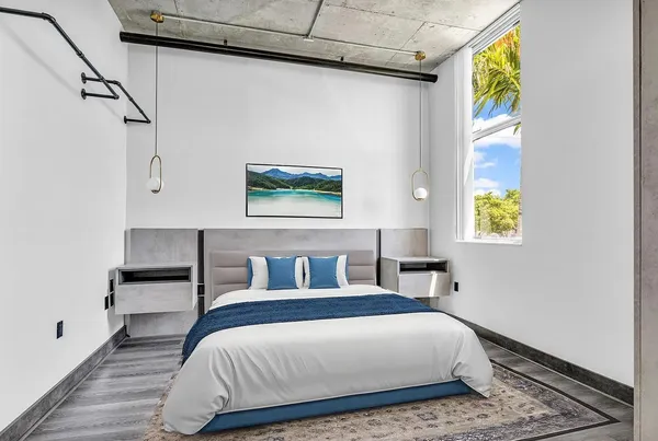 a bedroom with a bed and a window