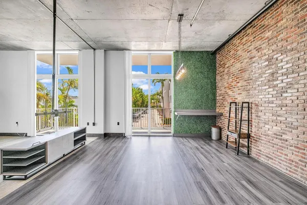a view of a room with wooden floor and outdoor space