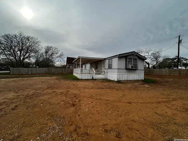 a view of house with outdoor space and sitting area