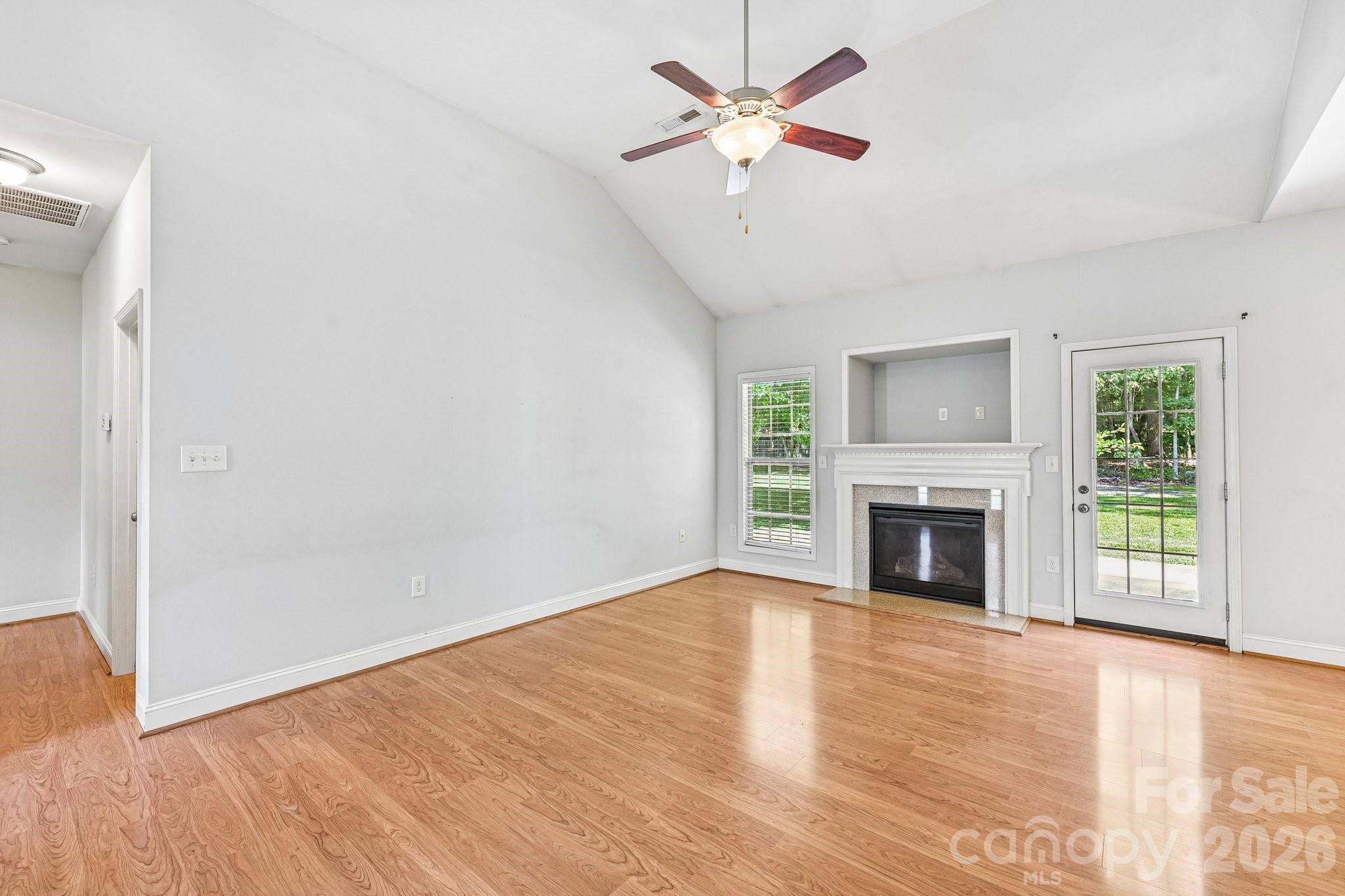 624 Hunley Street Monroe, NC 28112 - Photo 10 of 36 a view of empty room with a fireplace and wooden floor