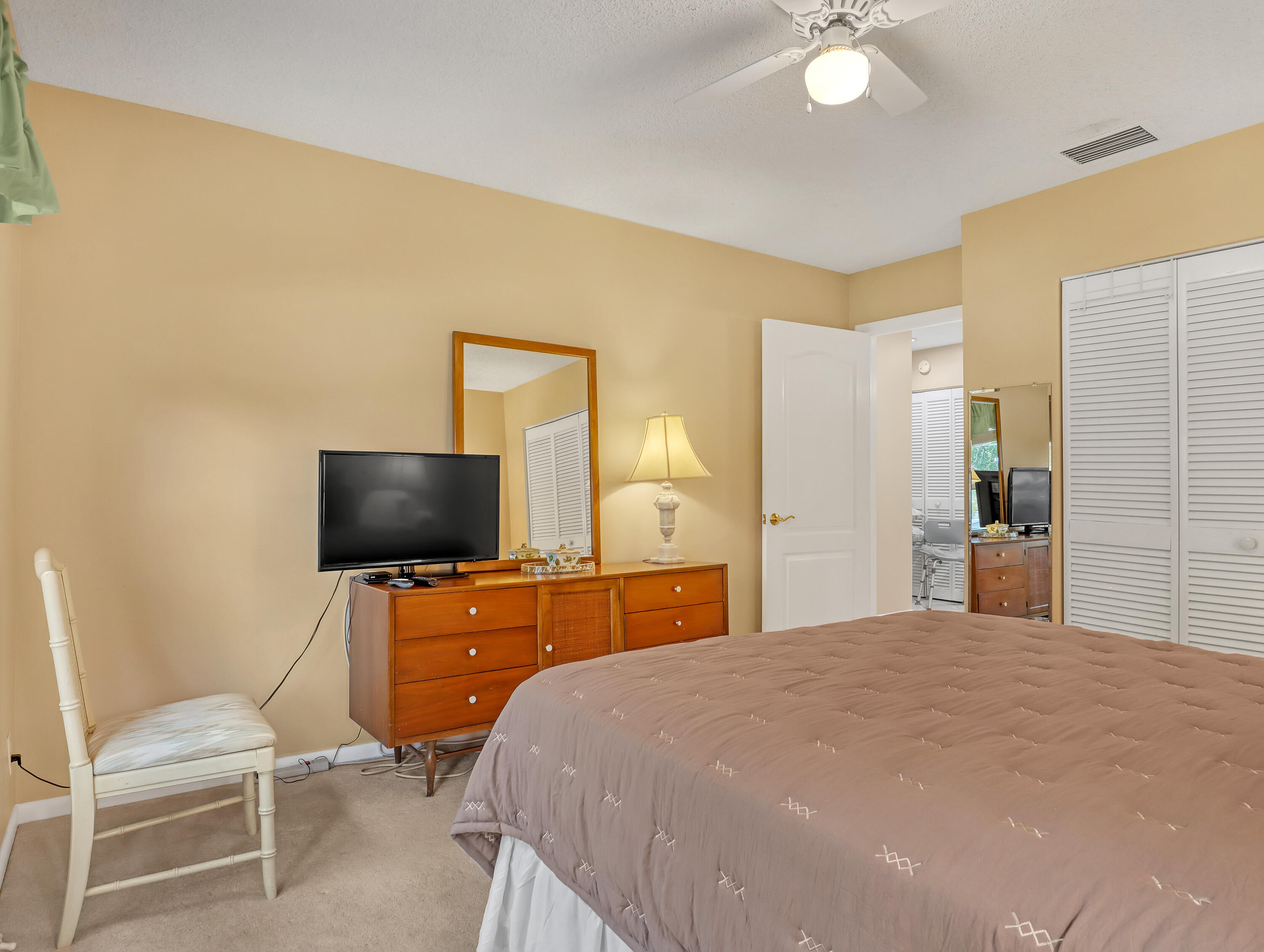 712 Golf Court Delray Beach, FL 33445 - Photo 29 of 46 a bedroom with a bed and a flat screen tv