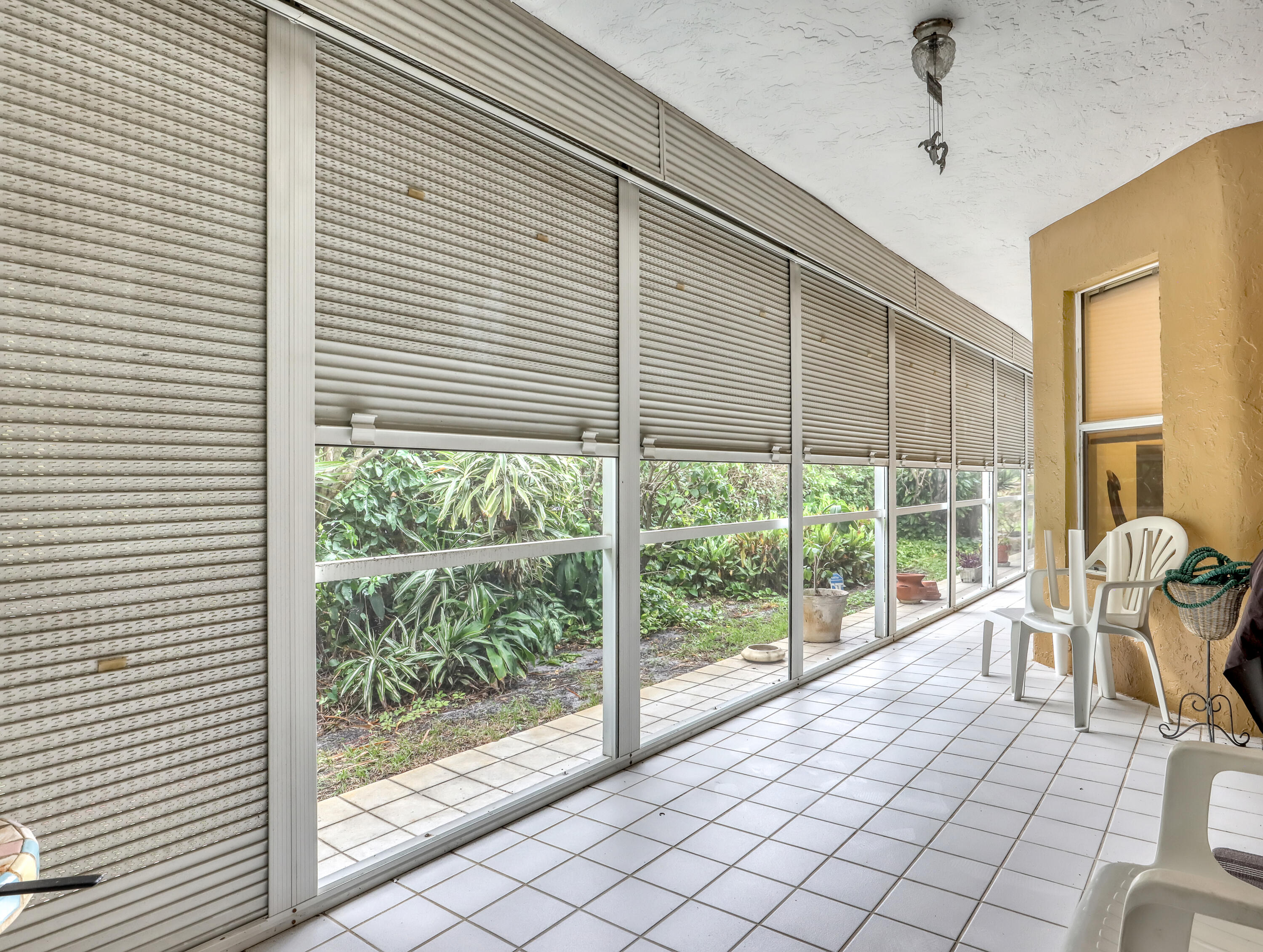 712 Golf Court Delray Beach, FL 33445 - Photo 33 of 46 a view of a porch with a table and chairs