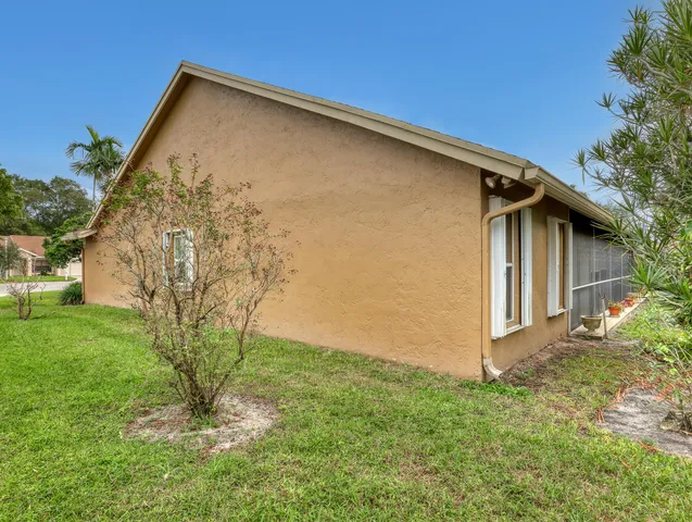 a view of a house with a small yard and wooden fence