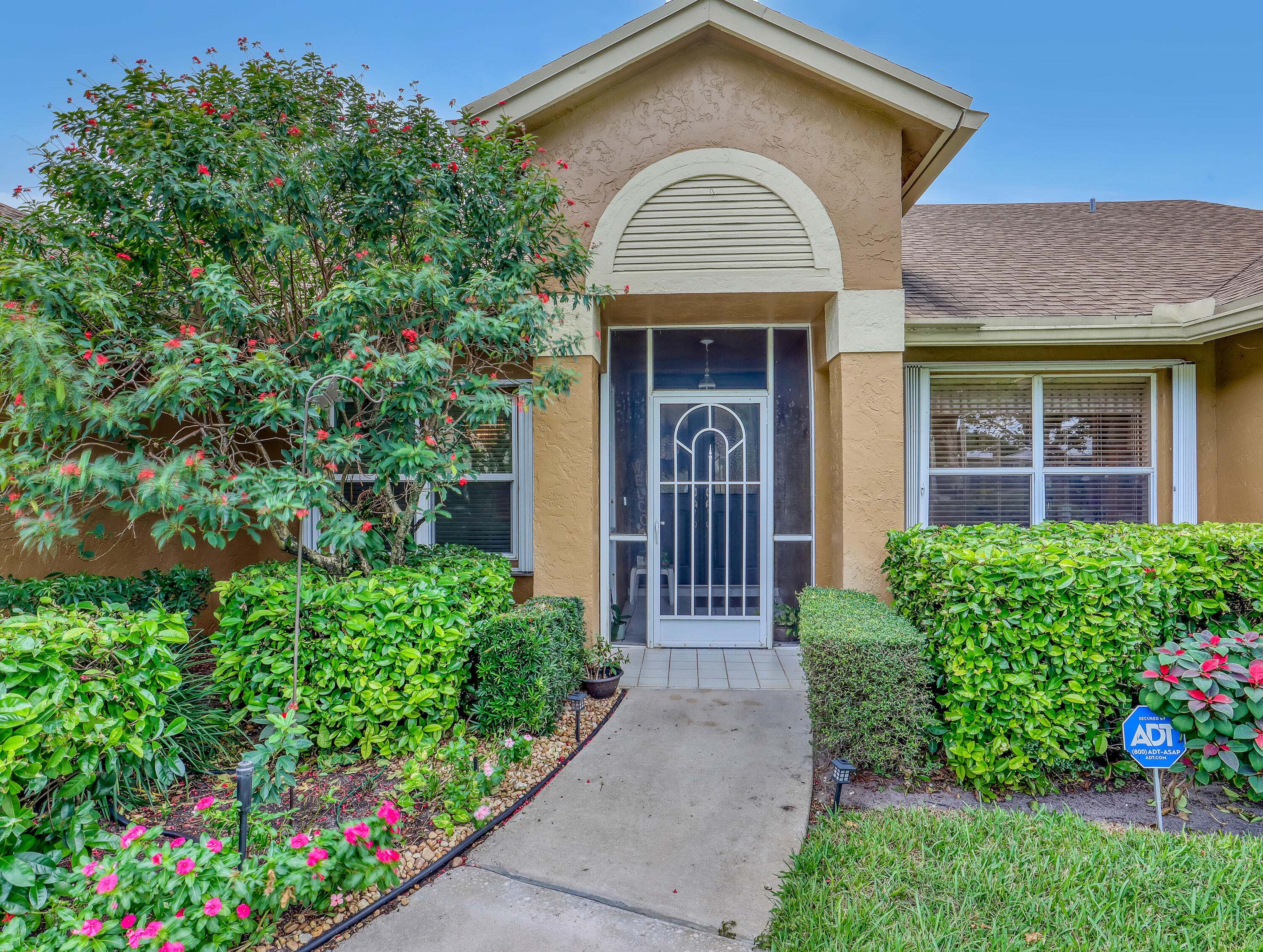 712 Golf Court Delray Beach, FL 33445 - Photo 4 of 46 a front view of a house with a yard