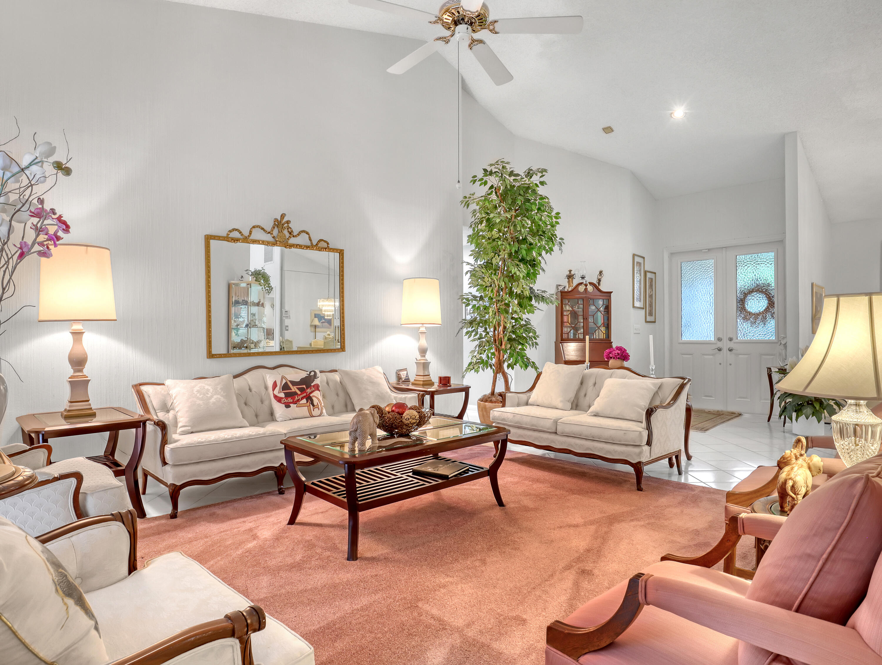 712 Golf Court Delray Beach, FL 33445 - Photo 9 of 46 a living room with furniture and a large mirror