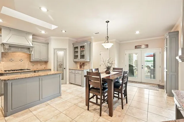 a large kitchen with a table and chairs