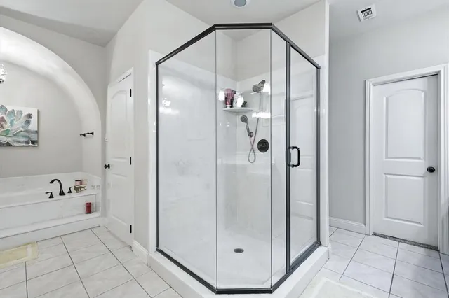a bathroom with a bathtub and a shower