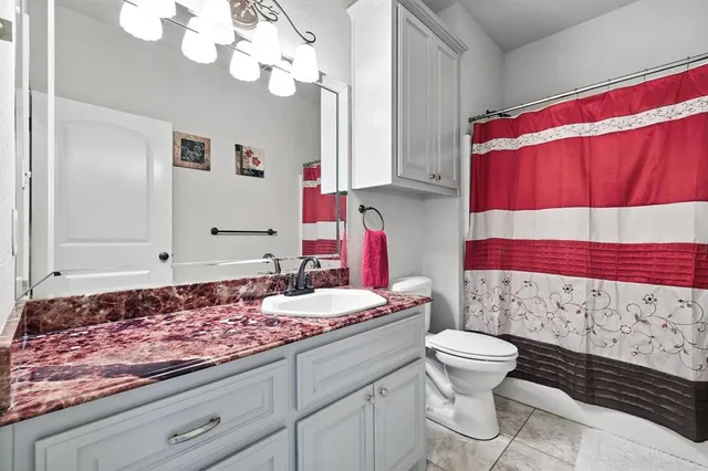 a bathroom with a sink a toilet and mirror