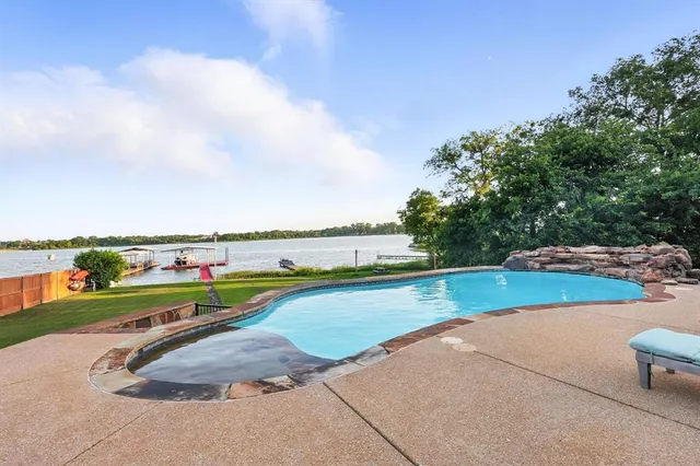 a view of a swimming pool with an outdoor seating and a yard