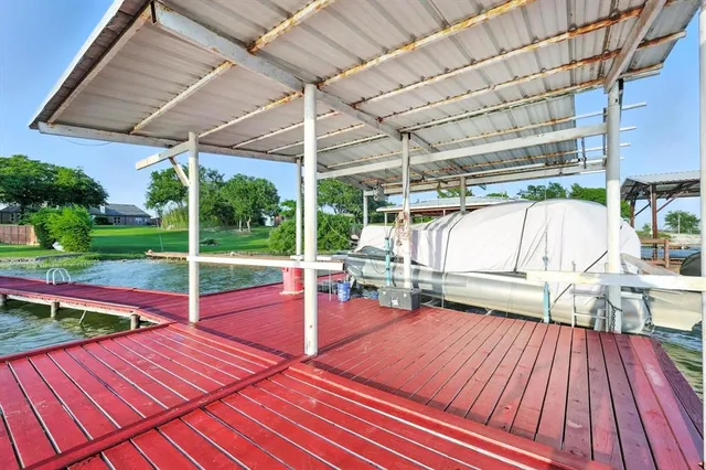 a view of a patio with a table and chairs under an umbrella