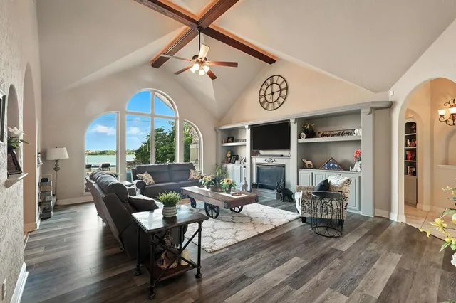 a living room with couches a dining table and chairs with wooden floor