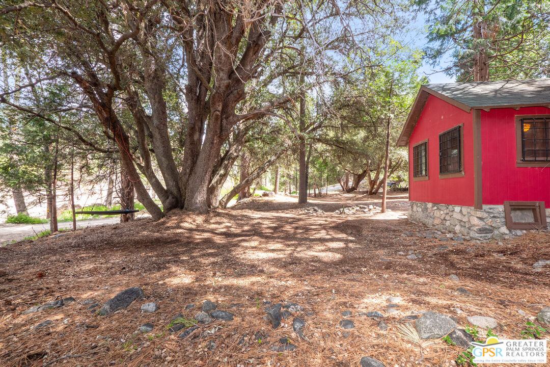 76 7 Oaks Road Angelus Oaks, CA 92305 - Photo 25 of 35 a front view of a house with a yard