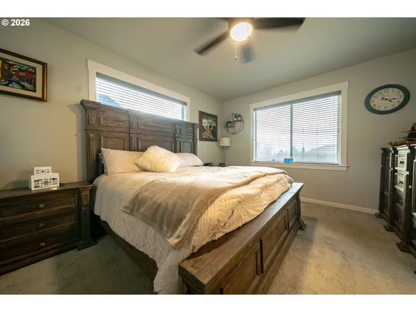 a bedroom with a bed and a flat tv screen on the dresser