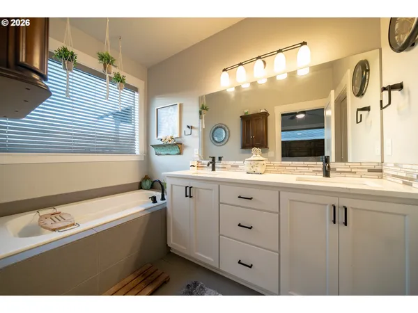 a bathroom with a sink a large mirror and a bathtub