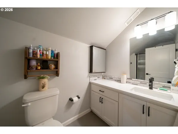 a bathroom with a sink a mirror and a toilet