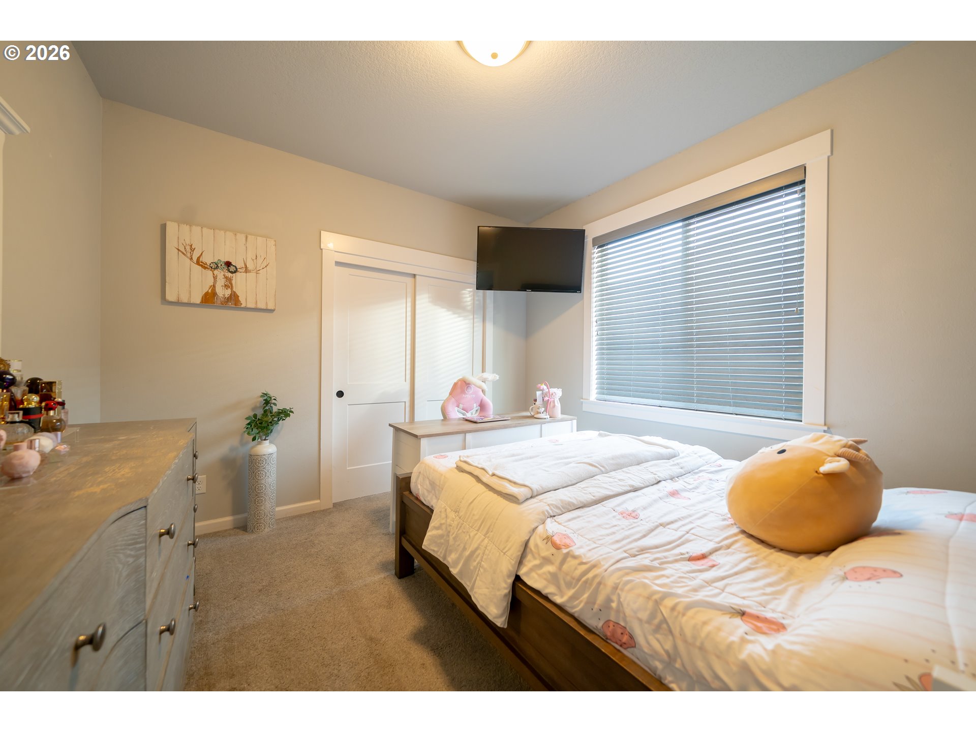 459 Northeast Cedar Street Sublimity, OR 97385 - Photo 16 of 27 a bedroom with a bed and a chandelier