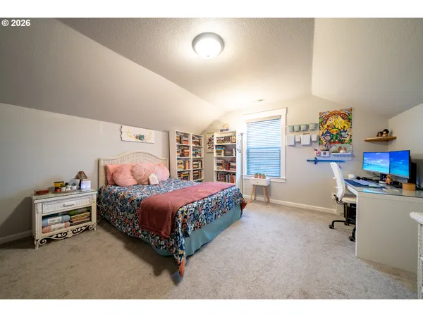 a bedroom with a bed and a book shelf