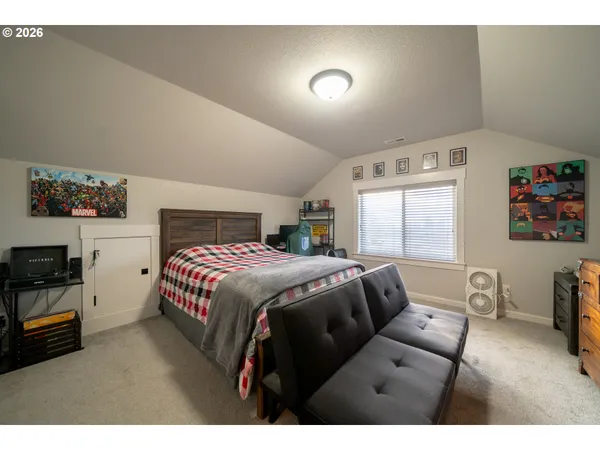 a bedroom with a bed and a tv