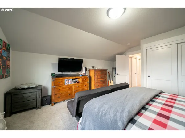 a bedroom with a bed and a television
