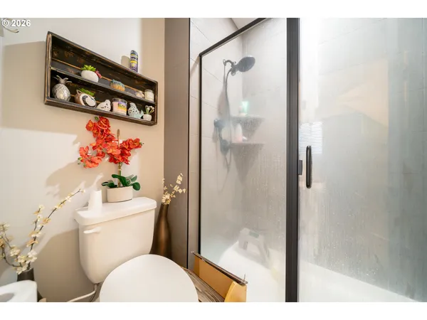 a bathroom with a toilet a sink and shower