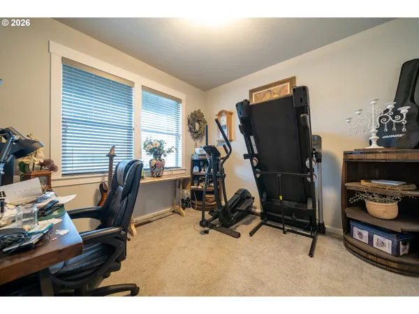 a view of a workspace with furniture and gym equipment