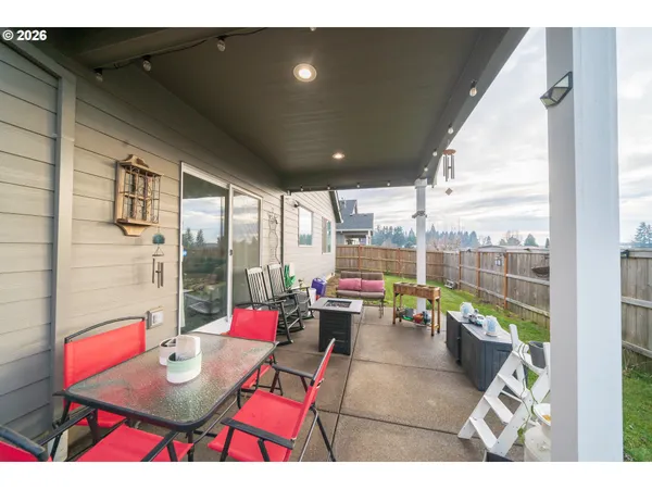a living room with patio furniture and a potted plant