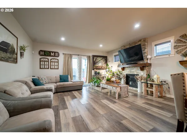 a living room with furniture flat screen tv and a fireplace