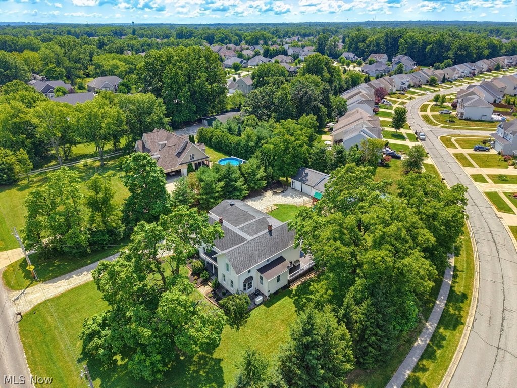 23055 Snell Road Columbia Station, OH 44028 - Photo 46 of 50 Aerial perspective showcasing a residential property with a light-colored exterior and dark roof, surrounded by mature trees and manicured lawns