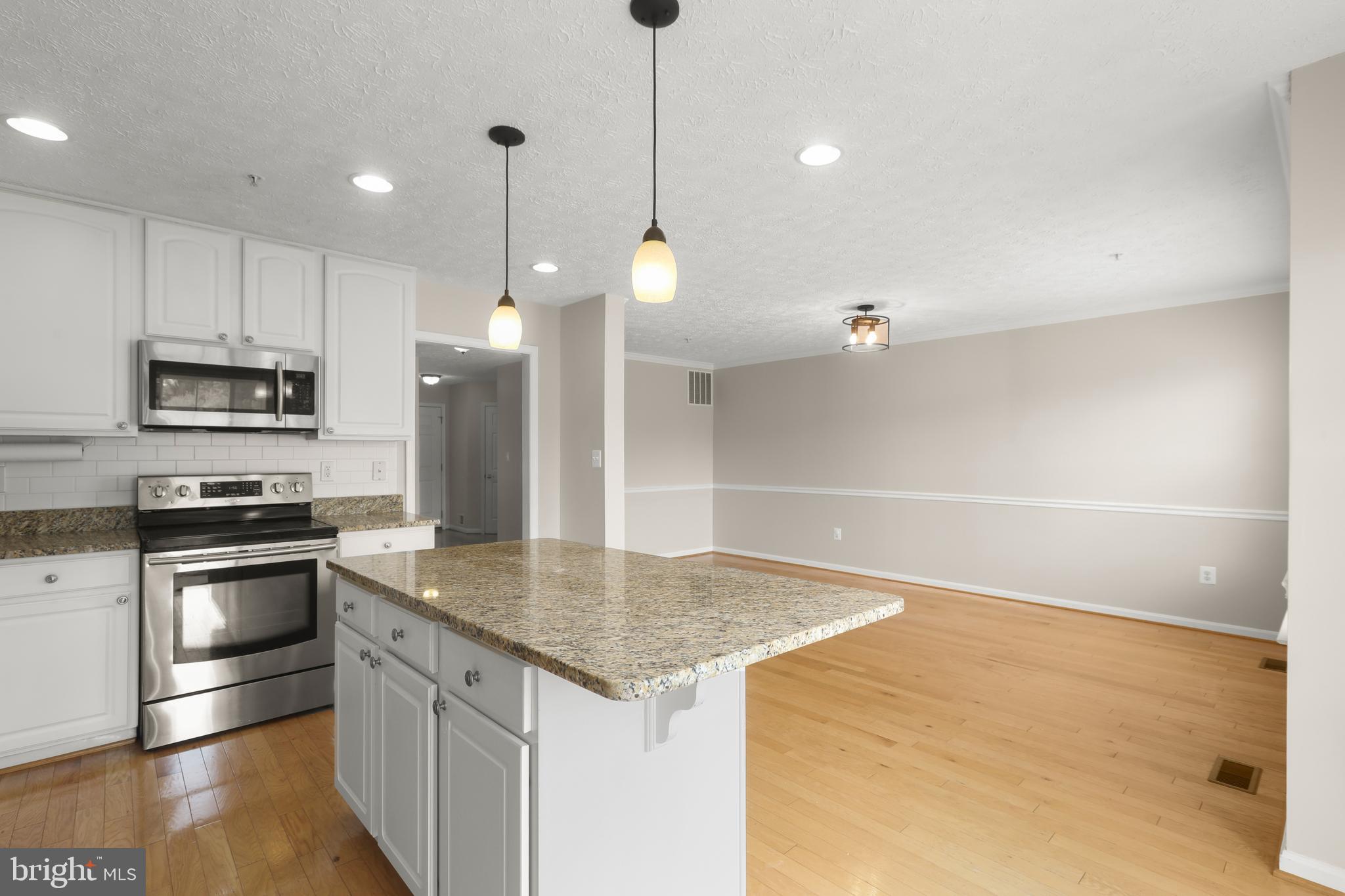 1983 Cullen Way Forest Hill, MD 21050 - Photo 13 of 50 a kitchen with stainless steel appliances granite countertop a sink a stove and a refrigerator