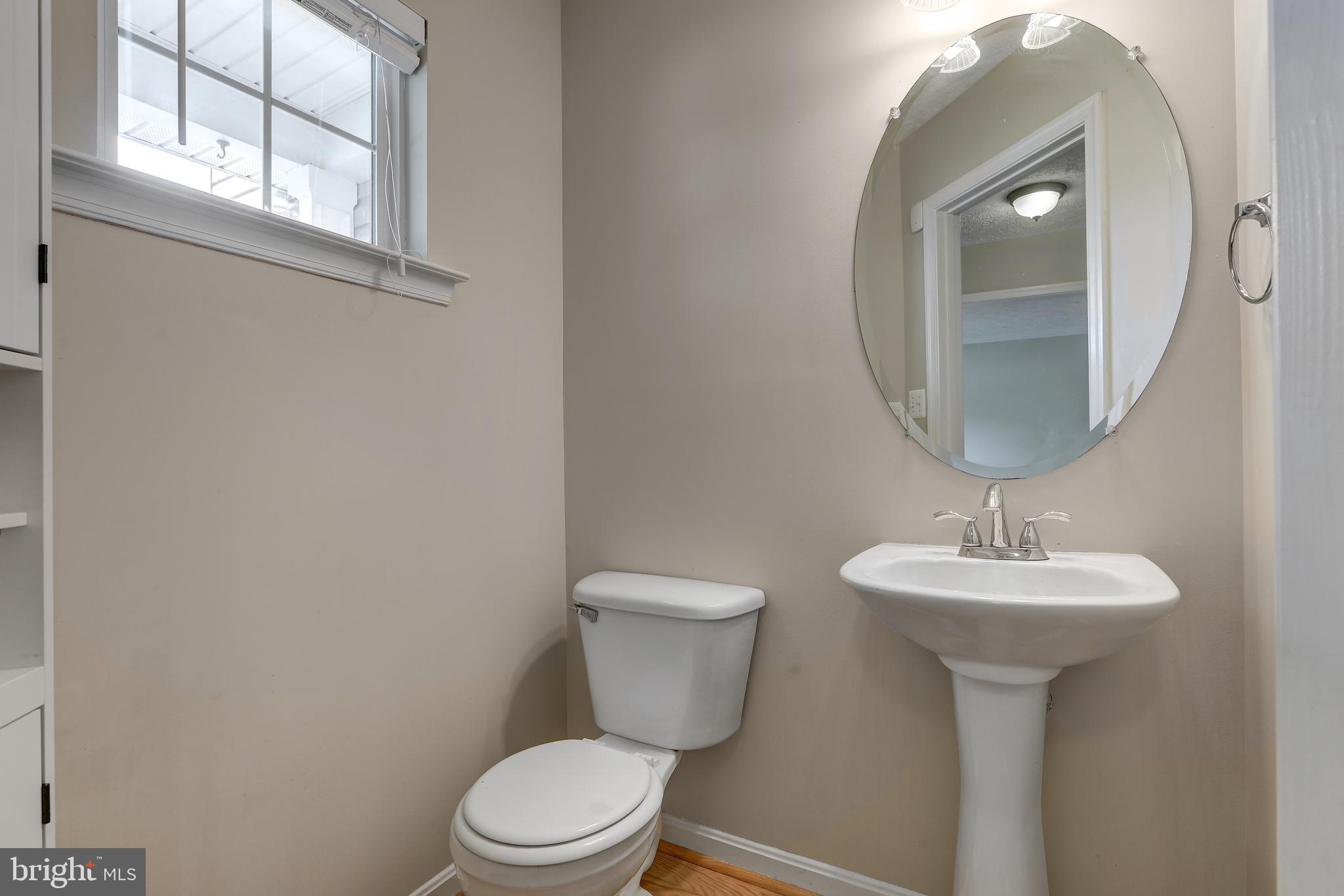 1983 Cullen Way Forest Hill, MD 21050 - Photo 18 of 50 a bathroom with a toilet sink and mirror