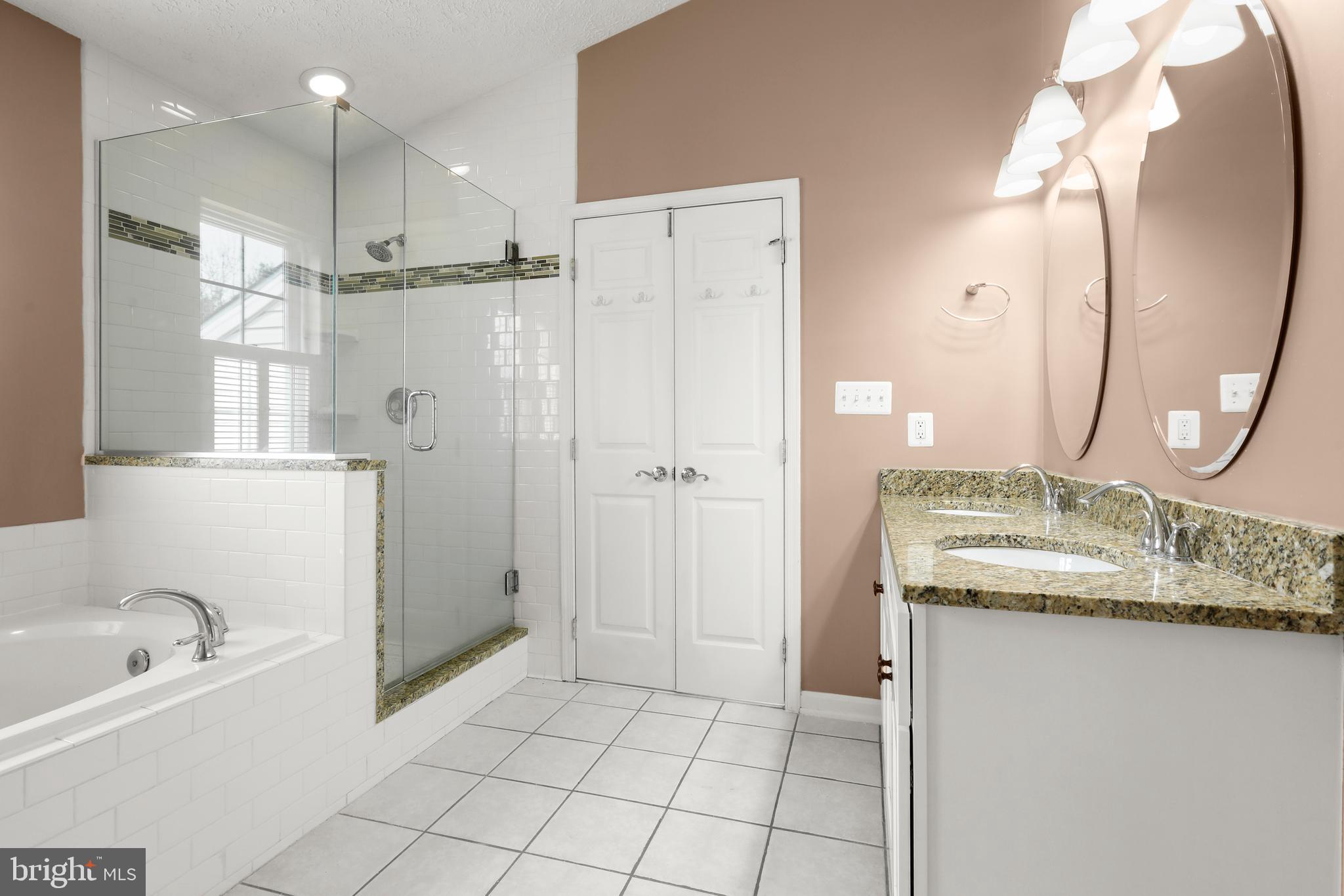 1983 Cullen Way Forest Hill, MD 21050 - Photo 25 of 50 a bathroom with a granite countertop sink two mirror a bathtub and shower