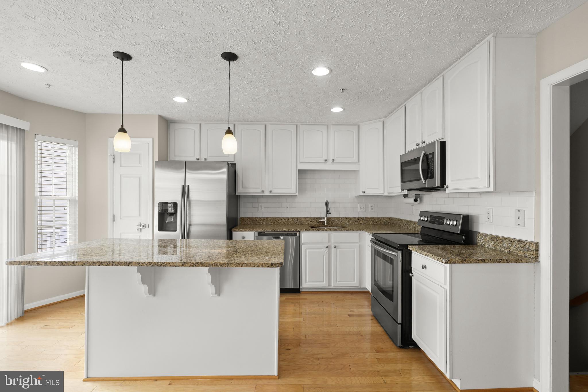 1983 Cullen Way Forest Hill, MD 21050 - Photo 8 of 50 a kitchen with stainless steel appliances granite countertop a sink a stove a refrigerator and a microwave