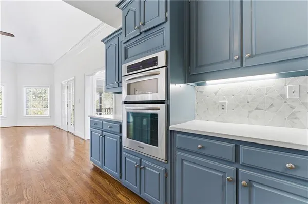 a kitchen with stainless steel appliances granite countertop a refrigerator and cabinets