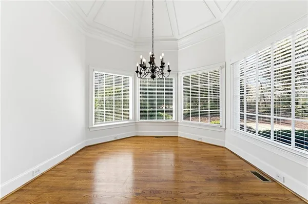 a view of an empty room with a fireplace and a window