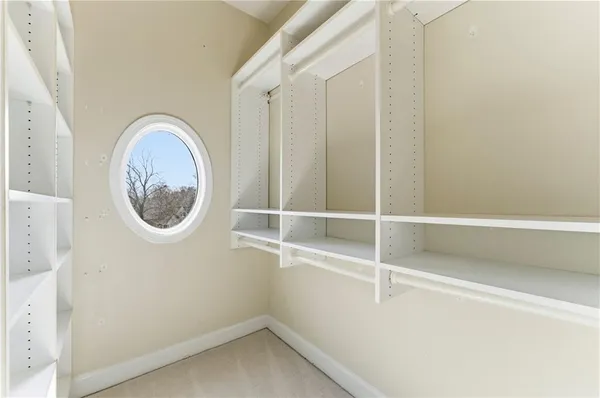 a bathroom with a granite countertop sink a mirror and a toilet