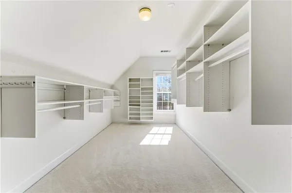 an empty room with windows and ceiling fan