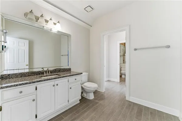 a large kitchen with stainless steel appliances double vanity and a sink
