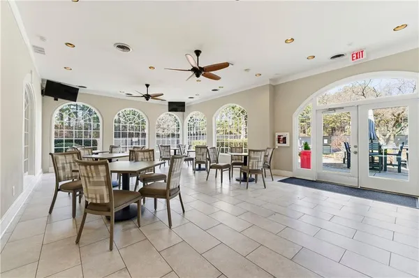 a view of a dining room with furniture and a chandelier