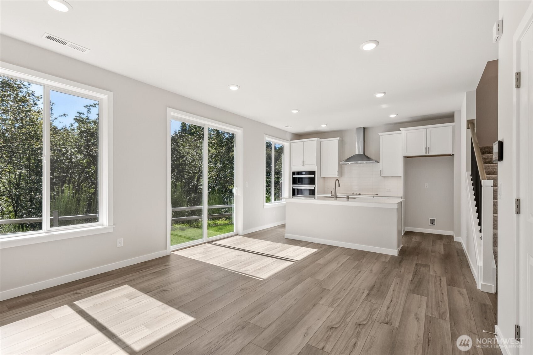 32321 134th Street Southeast Sultan, WA 98294 - Photo 2 of 27 a large white kitchen with wooden floors and glass windows