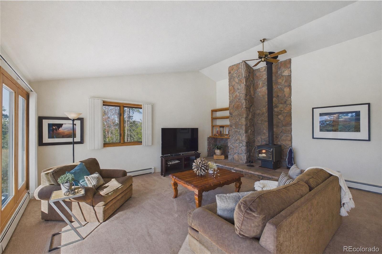 10798 Crystal Way Morrison, CO 80465 - Photo 5 of 36 a living room with furniture wooden floor and a flat screen tv